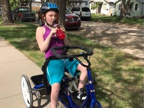 Tobi-Dawne Smith's child Red rides the adaptive bike, which was stolen at some point from the family's garage.