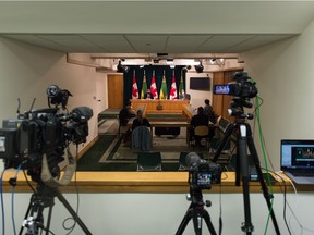 Cameras are trained on a news conference, regarding COVID-19, held at the Saskatchewan Legislative Building in Regina, Saskatchewan on Mar. 9, 2021. Both Saskatchewan's chief medical health officer Dr. Saqib Shahab and Premier Scott Moe spoke during the conference and can be seen at the lit desk in the back of the room.