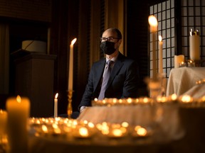 Funeral director Morgan Edwards is photographed with hundreds of candles at the Saskatoon Funeral Home, which symbolize the lives lost in Saskatchewan due to the COVID-19 pandemic. Photo taken in Saskatoon on Monday, March 15, 2021.