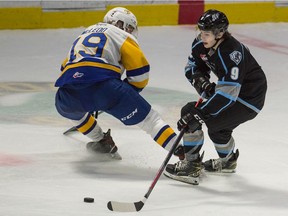 Winnipeg Ice's Zach Benson (9) tries to keep the puck from the Saskatoon Blades' Wyatt McLeod (19) during a WHL hockey game at the Brandt Centre in Regina. Saskatchewan on March 17, 2021. (BRANDON HARDER/ Regina Leader-Post)