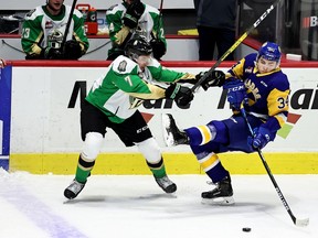 Prince Albert Raiders' Remy Aquilon (7) checks the Saskatoon Blades' Colton Dach (34) on March 29, 2021 at the Brandt Centre. Keith Hershmiller Photography.