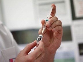 A medical worker draws the Pfizer-BioNTech COVID-19 vaccine from a vial.