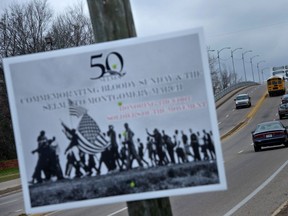 (FILES) In this file photo a sign commemorating voting rights marches is seen at the base of the Edmund Pettus Bridge near where Bloody Sunday began on Route 80 on March 5, 2015 in Selma, Alabama. - US President Joe Biden will sign an executive order on March 7, 2021, to make it easier for Americans to vote to commemorate the 56th anniversary of the "Bloody Sunday" civil rights march when peaceful activists were attacked by police in Selma, Alabama. Biden's move comes as several Republican-controlled state legislatures push to curtail voting access in response to Donald Trump's election loss and his repeated false claims of election fraud.