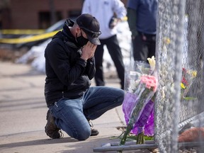 Conrad Wright leaves flowers and takes a moment at the site of a mass shooting at King Soopers grocery store, in Boulder, Colorado, U.S., March 23, 2021.  REUTERS/Alyson McClaran