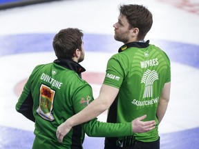 Team Saskatchewan skip Matt Dunstone, left, and second Kirk Muyres comfort each other after Sunday's heartbreaking loss to Alberta's Brendan Bottcher in the Brier semi-final.