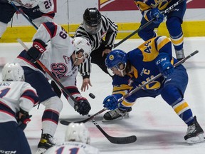 The Regina Pats' Logan Nijhoff (29) faces off with the Saskatoon Blades' Chase Wouters (44) during Friday's early WHL game at the Brandt Centre. Brandon Harder/Regina Leader-Post.