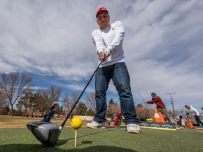 Chris Elder tees up the ball on the driving range at Silverwood Golf Course. Photo taken in Saskatoon, SK on Thursday, April 8, 2021.