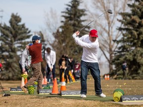 Chris Elder tees up a ball on the driving range at Silverwood Golf Course on April 8, 2021. Driving ranges at Holiday Park and Silverwood golf courses opened at the beginning of April and the courses are set to open Friday.