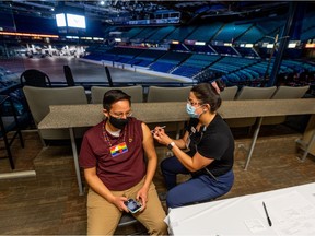 Jack Saddleback receives his first dose of vaccine at the Saskatoon Tribal Council (STC) COVID-19 vaccine clinic in the Sasktel Centre.