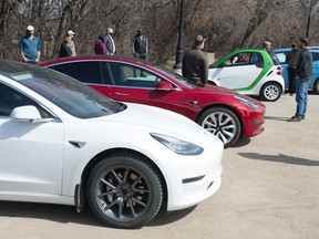 Electric vehicle owners and advocates gather to speak to MLAs regarding the new electric vehicle tax in front of the Saskatchewan Legislative Building in Regina, Saskatchewan on April 10, 2021.