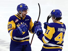 Moose Jaw Warriors vs. Saskatoon Blades on April 9, 2021 at the Brandt Centre. Wyatt McLeod (19) and Rhett Rhinehart (41) of Saskatoon. Keith Hershmiller Photography.