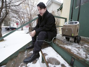 Matthew Cardinal sits on his front porch with his oxygen tank in Regina on Thursday, April 15, 2021.