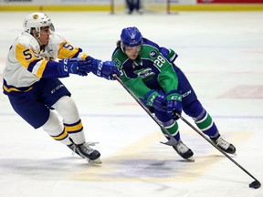 Swift Current Broncos' Sam McGinley (28) and Saskatoon Blades' Marek Schneider (55) at the Brandt Centre on April 17, 2021. Keith Hershmiller Photography.