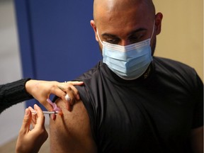 Saskatoon Police Service Const. Tejpal Virk receives his first COVID-19 immunization at the STC clinic at SaskTel Centre, where more than 300 frontline officers will be getting vaccinated on Wednesday and Thursday thanks to Saskatoon police partnership with Saskatoon Tribal Council. Photo taken in Saskatoon on Friday April 16, 2021.