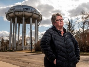 Christine Greer stands in front of the North Battleford water tower. Twenty years ago, thousands of people in North Battleford, including Greer, became ill due to the presence of the parasite cryptosporidium in their drinking water. Photo taken in North Battleford, SK on Monday, April 26, 2021.