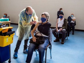 A nurse from Humber River Hospital administers the Pfizer/BioNTech COVID-19 vaccine at St Fidelis Parish in Toronto on March 17, 2021.