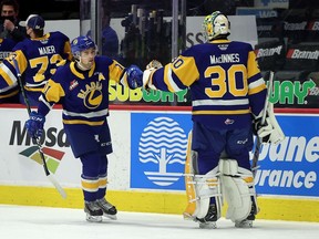 The Saskatoon Blades' Tristen Robins (11) celebrates a goal with netminder Koen MacInnes on Saturday at the Brandt Centre. Robins had two goals in a 4-2 victory over the Moose Jaw Warriors.