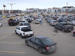 Vehicles line up at Evraz Place in Regina for the drive-thru vaccination clinic, which is distributing the AstraZeneca vaccine to people aged 64.