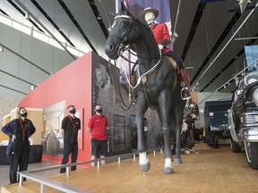 Staff at the RCMP Heritage Centre demonstrate some of the new safety protocols as they reopen after being closed during the pandemic in Regina on Wednesday, July 8, 2020. One way foot traffic, hand sanitizer and face masks are some of the rules put in place.