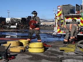Firefighters work at the scene of a fire that destroyed a building in the 100 block of Avenue B South. Photo taken in Saskatoon on Monday May 3, 2021.