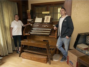 Don Murdoch's niece Betty Warke and her son Tyler Dash stand next to his custom built pipe organ. The instrument, which took decades to construct, is built into the walls and floor of the home.