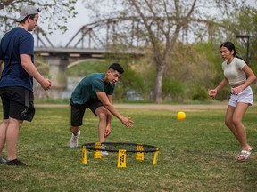 SASKATOON, SK--MAY 17/2021 - 0518 Spec Weather - Riley Darmokid, Colby Senger, and Maezel Gonzales (left to right) play a game of spike ball in Rotary Park. Photo taken in Saskatoon, SK on Monday, May 17, 2021.