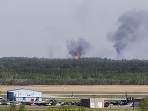 Flames and smoke rise from a fire north of Prince Albert. Photo taken in Prince Albert on Tuesday, May 18, 2021.