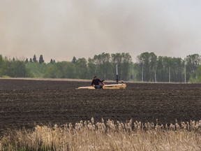 Derek Dery examines the soil on his farm. Fields across the Canadian prairies and the U.S. Northern Plains are among the driest on record.