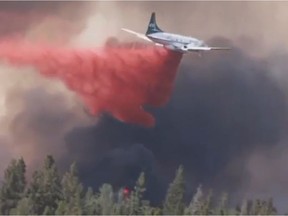 A video screenshot shows water bombers and a helicopter fighting a wildfire near Prince Albert on May 17, 2021.