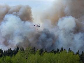 Water droppers battle an out of control forest fire after the city of Prince Albert declared a state of emergency over a fast-moving wildfire, prompting some residents to evacuate, in Prince Albert, Sask.