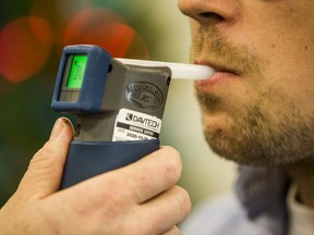 Scott McGregor, SGI Communications Consultant, tests out an approved screening device for alcohol, commonly referred to as a breathalyzer, at a demonstration on the tools the Saskatoon Police Service is using to combat impaired driving in this file photo from December 2019.