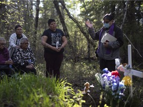 A pastor gives a prayer during a vigil at Little Red River Park for Braden Herman in Prince Albert, Sask., on Saturday, May 29, 2021.