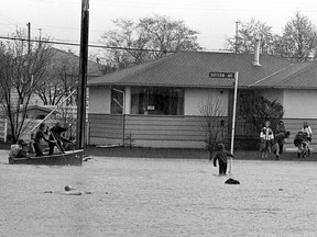 Children play in the water at Dufferin Avenue, just south of Bute Street.