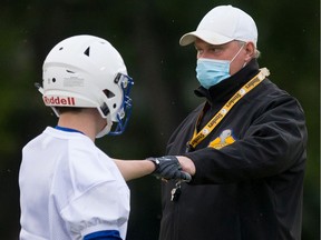Saskatoon Hilltops head coach Tom Sargeant fist pumps with one of the football players during a practice during the COVID-19 pandemic. Photo taken in Saskatoon on Wednesday, September 9, 2020.