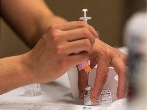 A nurse draws a dose of Pfizer-BioNTech vaccine at the Saskatoon Tribal Council (STC) COVID-19 vaccine clinic in the Sasktel Centre. Photo taken in Saskatoon, SK on Friday, April 9, 2021.