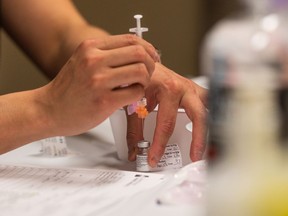 SASKATOON, SK--APRIL 9/2021 - 0410 news covid stc clinic - A nurse draws a dose of Pfizer-BioNTech vaccine at the Saskatoon Tribal Council (STC) COVID-19 vaccine clinic in the Sasktel Centre. The STC is running the clinic in partnership with the Saskatchewan Health Authority.