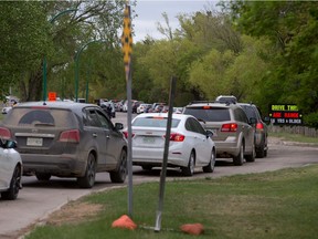 Vehicles lined up around the block with an estimated six-hour wait time to get into Prairieland Park's drive-thru COVID-19 immunization clinic on May 19, 2021. (Saskatoon StarPhoenix / Michelle Berg)