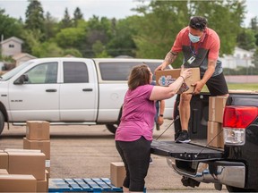 Saskatoon Public Schools Foundation staff and volunteers load up food and educational tools to distribute to families as part of their Cheer Crates Campaign on Tuesday, June 22, 2021.