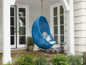 Rattan and wicker furniture, real or faux, adds style to outdoor and indoor living spaces. This front porch is ready for entertaining, with siding painted in Dove Wing (OC-18) from Benjamin Moore's Aura exterior paint line. The doors are painted in Decorator's White (OC-149) from the Aura Grand Entrance collection. (Photo: Benjamin Moore)