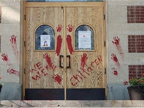 The doors of St. Paul's Co-Cathedral were marked with red paint on June 24, 2021 in response to the announcement from Cowessess First Nation that 751 unmarked graves graves had been identified near the former Marieval Residential School. Facebook: Donna Heimbecker.