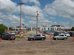 Vehicles are seen sitting in line for a drive-thru COVID-19 vaccine clinic at Evraz Place in Regina, Saskatchewan on June 26, 2021. The Saskatchewan Health Authority advised people via Twitter that the queue was closed to new cars at 8:34 a.m. Saturday. BRANDON HARDER/ Regina Leader-Post