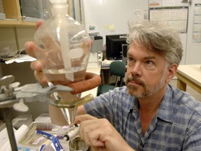 University of Regina biologist Peter Leavitt is shown here in 2012, collecting toxins out of water for a study of toxicity levels in Canadian lakes. (Don Healy / Leader-Post)