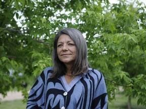 Ronalda Vandale, a member of the Muskoday First Nation, made plans to tie 215 pairs of shoes to a Muskoday First Nation bridge as a tribute to the 215 children whose remains were found at the site of a former residential school in Kamloops, B.C. Her display on June 21 coincides with National Indigenous People's Day. (Peter Lozinski / Prince Albert Daily Herald)