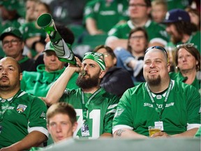 A Saskatchewan Roughriders fan blows his horn to support his team during a pre-season game against the Calgary Stampeders at Mosaic Stadium.