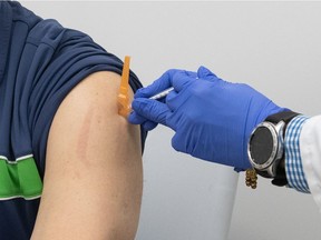 A patient gets his second dose of COVID-19 vaccine in Regina, Saskatchewan on June 11, 2021.