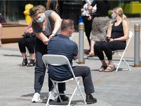 A man gets a vaccination at a pop-up COVID-19 vaccine clinic on Scarth Street in Regina, Saskatchewan on June 16, 2021.