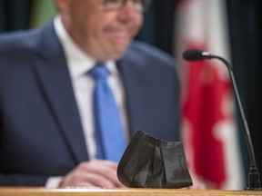 Premier Scott Moe's mask sits in front of him as he provides a COVID-19 update on Wednesday, July 7, 2021 in Regina.