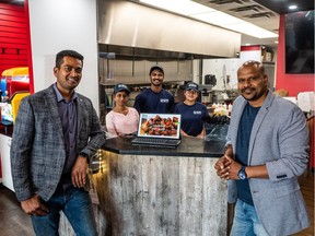 Drums of Heaven Owners Sunil Khandade, left, and Durgesh Pusekar, right, stand with general manager Sulekha and staff Joel and Kajal (left to right) at their restaurant in Saskatoon.