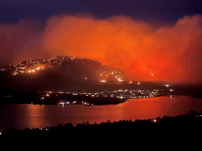 Smoke billows from a wildfire, seen from Highway 3 lookout near Osoyoos city, B.C., July 20, 2021.