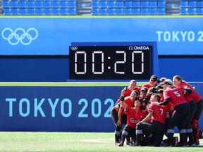 Canada players take pictures after winning the game.